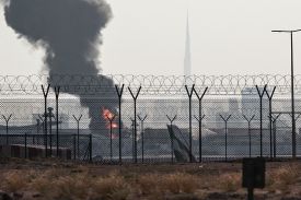 A view of the Dubai skyline shows a black cloud of smoke rising from a fire below.