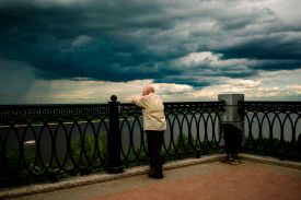 A man looks out over the Volga River during a storm in Nizhny Novgorod, Russia.