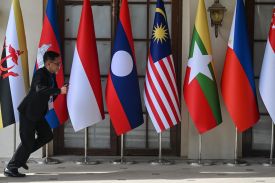 A man runs past national flags of Association of Southeast Asian Nations (ASEAN) member states in Cebu, Philippines, on May 5, ahead of the 48th ASEAN Summit.