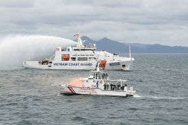 A Vietnam Coast Guard ship (background) uses its water cannon as it simulates the extinguishing of a fire on a Philippine Coast Guard boat during a joint maritime exercise off Bataan, Philippines, in the disputed South China Sea on Aug. 9, 2024.