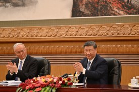 Chinese President Xi Jinping, right, and Cai Qi applaud at the Great Hall of the People in Beijing.
