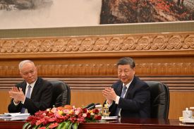 Chinese President Xi Jinping, right, and Cai Qi applaud at the Great Hall of the People in Beijing.