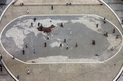Visitors walk by a world map carved in stone at a plaza in southwest China's Chongqing municipality on May 19, 2010.