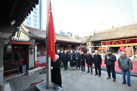 Muslim devotees conduct a national flag ceremony at a mosque in Beijing on March 21.