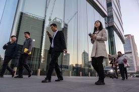 Employees leave their office towers at the end of the workday in Beijing.