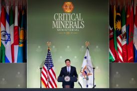 Rubio stands at a podium, flanked by the U.S. flag and the vice presidential flag. Behind him is a sign that reads "CRITICAL MINERALS MINISTERIAL."