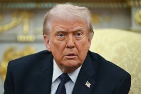 Donald Trump is seen staring while sitting in the Oval Office.