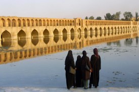 Iranian women watch the Si-o-Se Pol bridge on the Zayandeh River in Isfahan, Iran, on July 13, 2002.