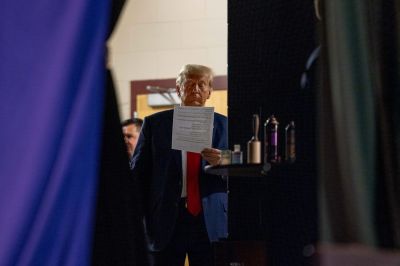 Republican presidential candidate former President Donald Trump reads a document backstage before after taking the stage on October 9, 2023 in Wolfeboro, New Hampshire.