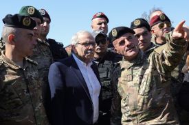 A Lebanese army officer shows to Lebanon’s Prime Minister Nawaf Salam an Israeli military positon on the horizon, in the southern village of Khiam near the border with Israel, on February 28, 2025.