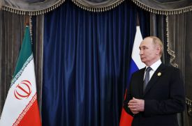 Russian President Vladimir Putin waits to greet Iranian President Masoud Pezeshkian prior to a Shanghai Cooperation Organisation meeting in Tianjin, China, on Sept. 1, 2025.