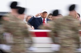 U.S. President Donald Trump salutes as a U.S. Army carry team moves a flagged-draped transfer case containing the remains of Sgt. 1st Class Nicole M. Amor at Dover Air Force Base March 07, 2026 in Dover, Delaware.