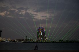 A man walks past a laser and light show during Eid Al-Fitr, marking the end of the holy month of Ramadan, in Abu Dhabi on March 20.