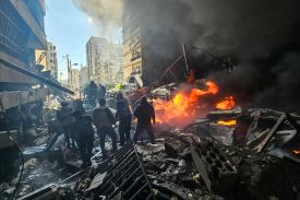 First responders stand amid rubble at the site of an Israeli airstrike in Beirut’s Corniche al-Mazraa neighborhood on April 8.