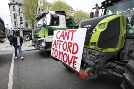 Members of the public make their way past trucks and tractors as fuel protesters block O’Connell Street in Dublin on April 11.