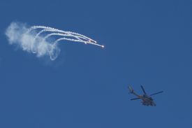 An Israeli Air Force AH-64 Apache attack helicopter fires flares while flying along the border between northern Israel and southern Lebanon on April 12.