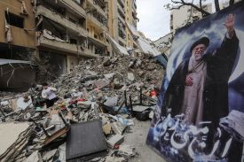 A boy stands amid the debris of a destroyed building next to a portrait of Iran’s slain supreme leader, Ayatollah Ali Khamenei, in the Haret Hreik area of Beirut’s southern suburbs in Lebanon.