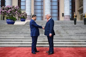 U.S. President Donald Trump is greeted by Chinese President Xi Jinping at the Great Hall of the People in Beijing.