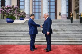 U.S. President Donald Trump is greeted by Chinese President Xi Jinping at the Great Hall of the People in Beijing.