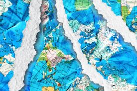 A disassembled world map with rips and tears.