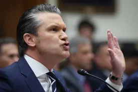 U.S. Defense Secretary Pete Hegseth raises a hand to accentuate a point as he addresses House lawmakers in the Rayburn Office Building on Capitol Hill.