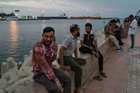 People celebrate Eid and watch oil tankers sail into Muscat Anchorage on March 22 at Sultan Qaboos Port in Muscat, Oman.