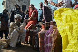People wait in a line to buy liquefied petroleum gas in a village on the outskirts of Jewar, India, on April 24.