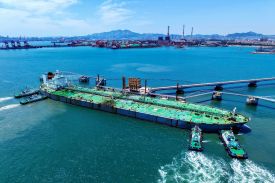 A ship loaded with oil docks at the port of Qingdao, in eastern China’s Shandong province.
