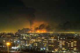 Smoke and flames rise at the site of airstrikes on an oil depot in Tehran.