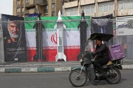 A motorist rides past models of Iranian missiles installed along the roadside at the Valiasr Square, in Tehran on March 22.