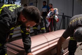 Civil defense paramedics and colleagues of those killed by an Israeli drone airstrike prepare a coffin in Al Nadja Hospital in Nabatieh, Lebanon.