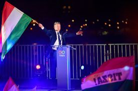 Incoming Hungarian Prime Minister Peter Magyar waves the national flag during election night celebrations in Budapest on April 12.