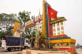 A truck drives past a flag of the Myanmar National Democratic Alliance Army raised on a welcome arch in Lashio, Myanmar, on April 9, 2025.
