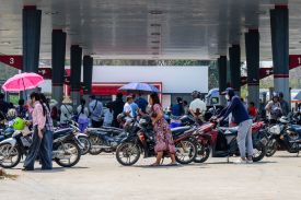 People line up to refuel their motorbikes outside a gas station in Naypyidaw, Myanmar, on March 29.
