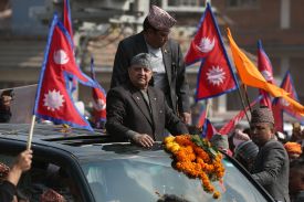 Former Nepali King Gyanendra Shah greets supporters in Kathmandu, Nepal, on Feb. 13.