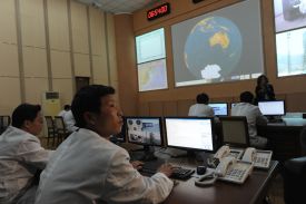North Korean technicians work in the control room of the Tongchang-ri space center on April 8, 2012.