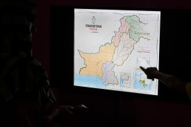 Journalists look at Pakistan’s new political map on a screen at the Daily Metrowatch newspaper offices in Islamabad.