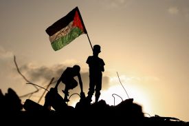 Palestinian children wave the Palestinian national flag at the Bureij camp for refugees in the central Gaza Strip.