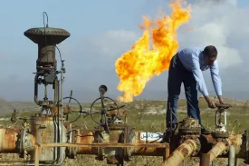 A worker turns a valve on the Kirkuk-Ceyhan pipeline at the Shirawa oilfield in Kirkuk, Iraq, in 2004.