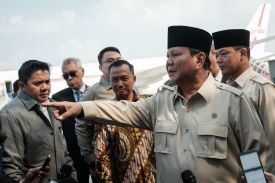 Indonesian President Prabowo Subianto gestures as he speaks to media on arrival from Egypt, where he attended the Gaza peace summit, at Halim Perdanakusuma Air Force Base in Jakarta, Indonesia, on Oct. 14, 2025.