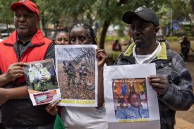 Relatives of Kenyan nationals conscripted by the Russian army pose with photos of their family members during a demonstration demanding government action to repatriate their kin, seen in Nairobi on Feb. 19.