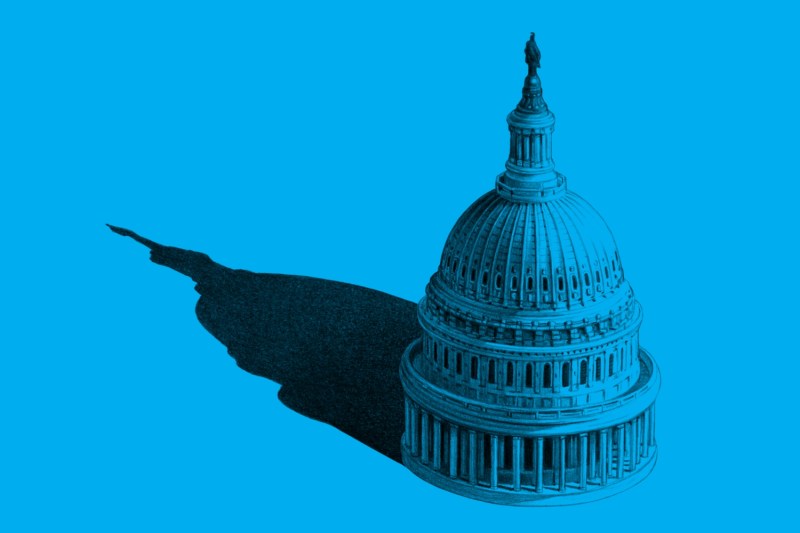 An illustration shows the U.S. Capitol on a blue field casting a long shadow.