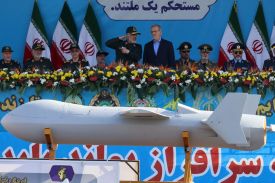 Iranian President Masoud Pezeshkian (right) and military officials look on as Iran's new Shahed 136-B drone is displayed during a military parade in Tehran on Sept. 21, 2024.