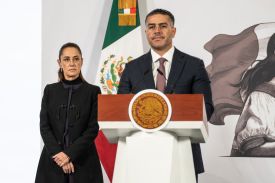 Mexican Secretary of Security and Citizen Protection Omar García Harfuch speaks while Mexican President Claudia Sheinbaum looks on during her daily morning briefing at the National Palace in Mexico City.