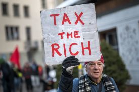 Phil White, a member of Patriotic Millionaires UK, participates in a demonstration ahead of the World Economic Forum in Davos, Switzerland, on Jan. 19, 2025.