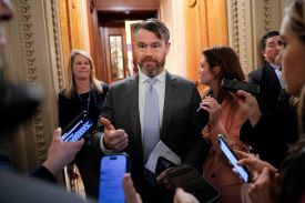 U.S. Republican Sen. Todd Young gestures while speaking to reporters inside the U.S. Capitol Building.