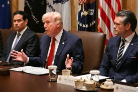 U.S. President Donald Trump is seen speaking during a Cabinet meeting and is flanked by Secretary of State Marco Rubio and Defense Secretary Pete Hegseth.