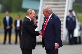 U.S. President Donald Trump shakes hands with Russian President Vladimir Putin.