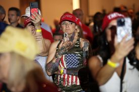 Supporters look on as U.S. President Donald Trump attends a roundtable discussion at the AC Hotel in Las Vegas, Nevada, on April 16.