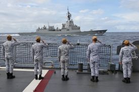Sailors aboard the Philippine Navy frigate BRP Jose Rizal salute a passing Royal Australian Navy destroyer during a naval exercise near Scarborough Shoal in the South China Sea on Sept. 3, 2025.